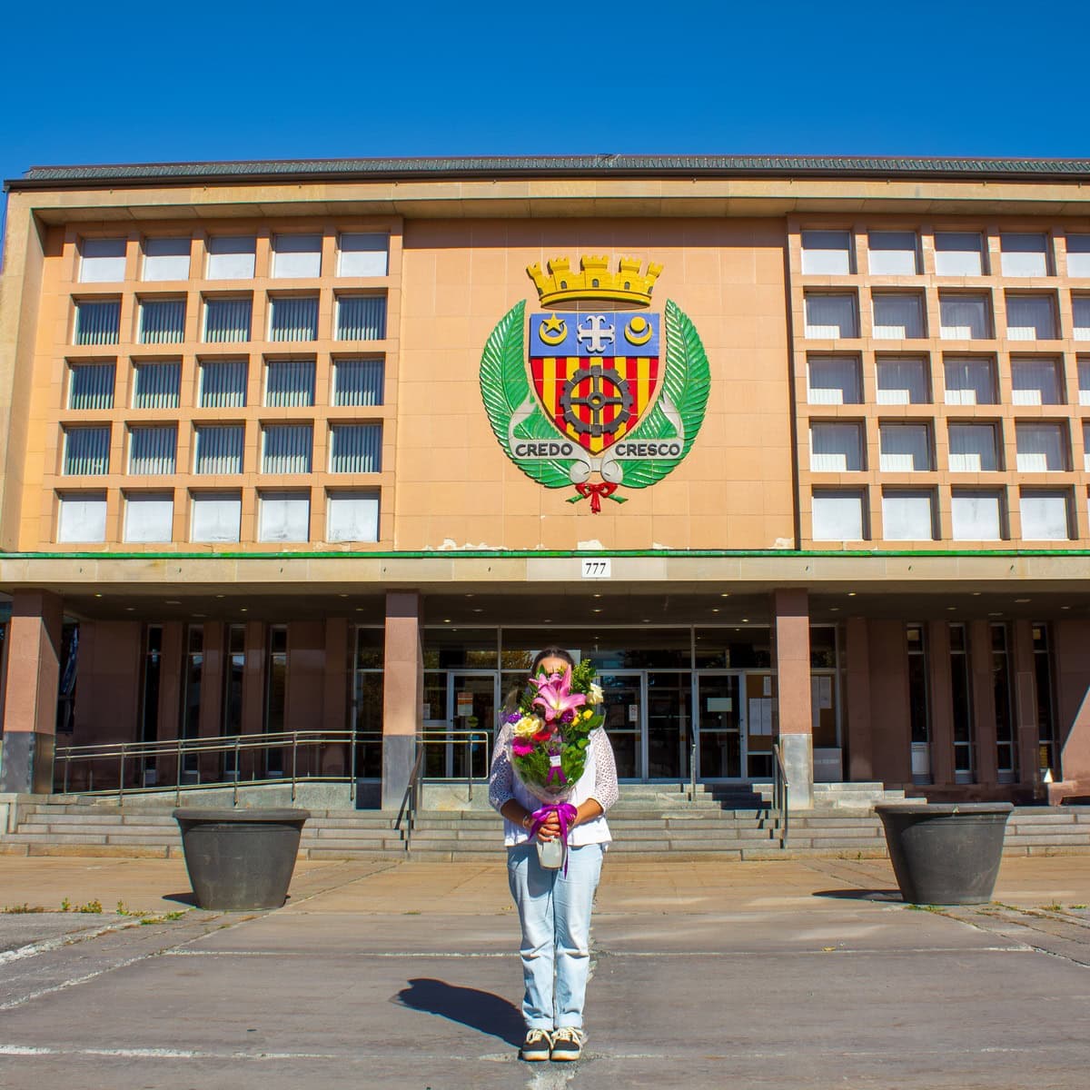 Person holding a colourful bouquet in front of Saint-Laurent City Hall in Montreal