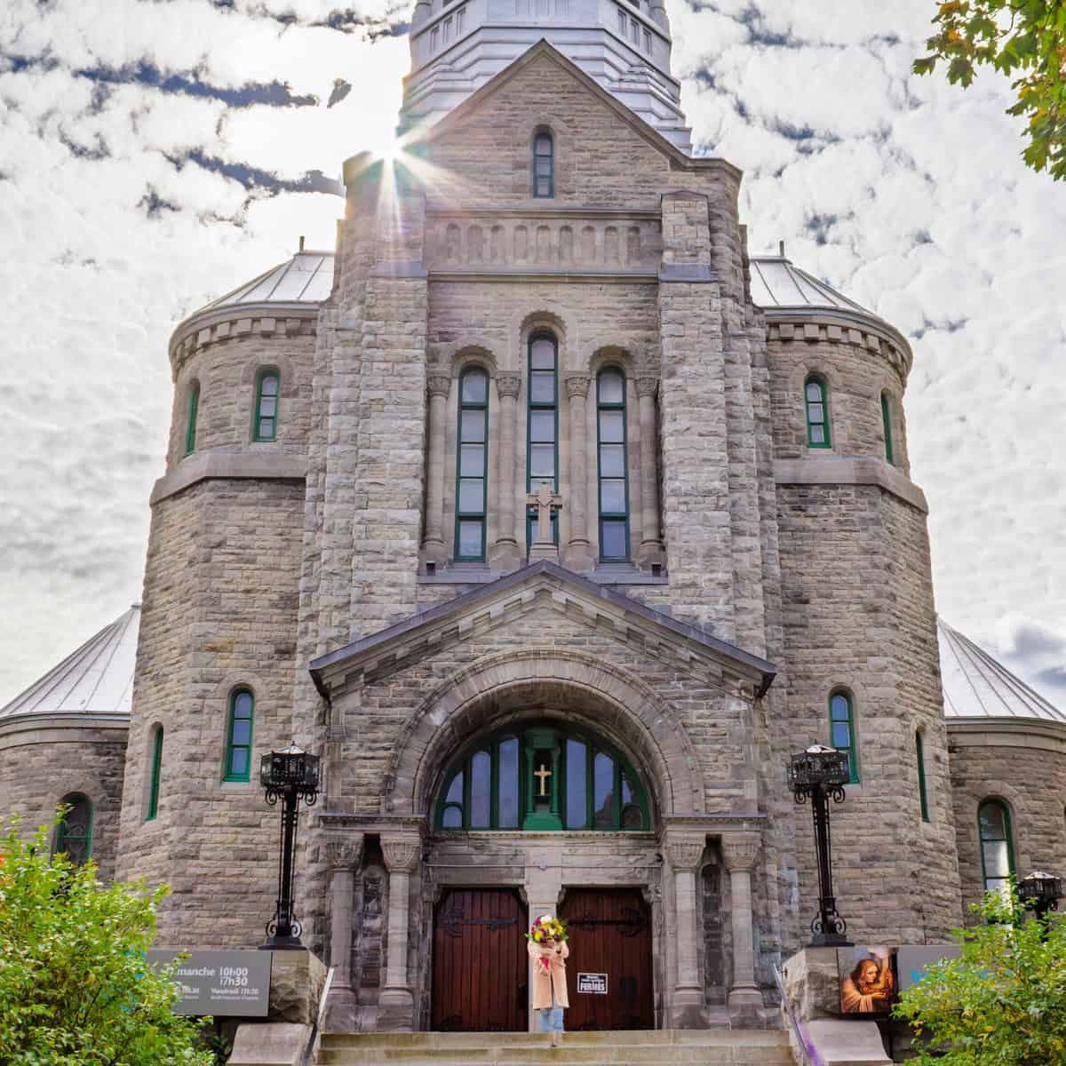 Person holding a colourful bouquet in front of Sainte-Madeleine d’Outremont church in Montreal
