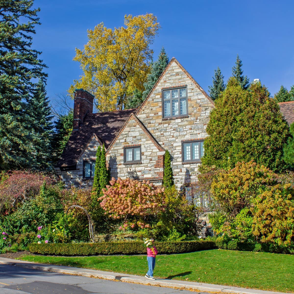 Person holding flowers on a residential street in Westmount, Montreal