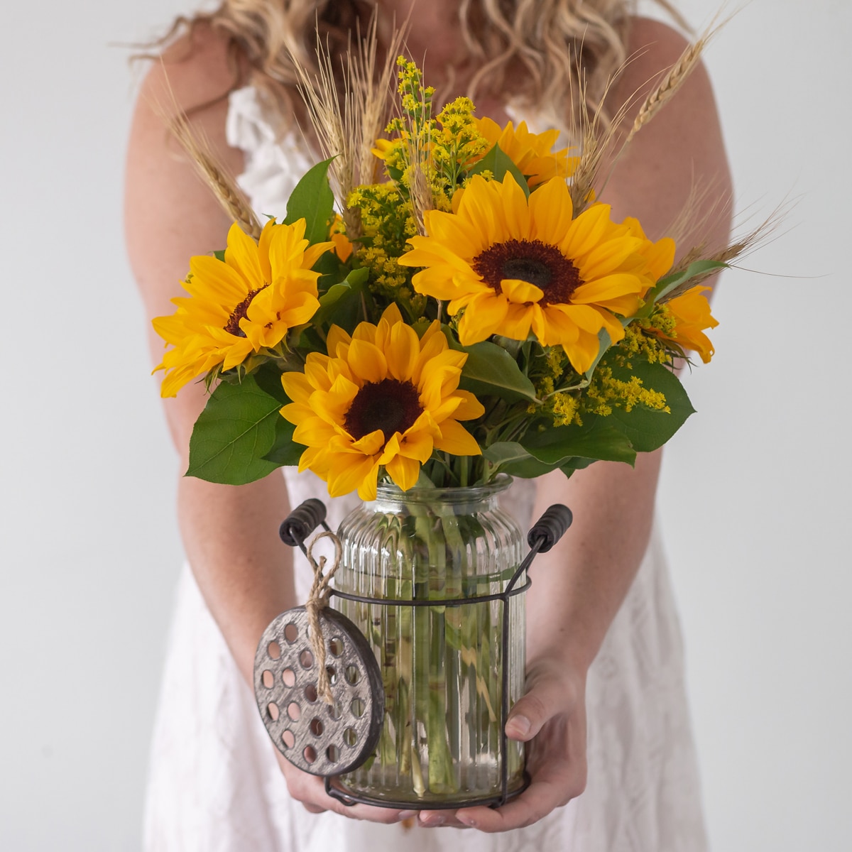 Yellow sunflowers frech-cut arranged in a vase.